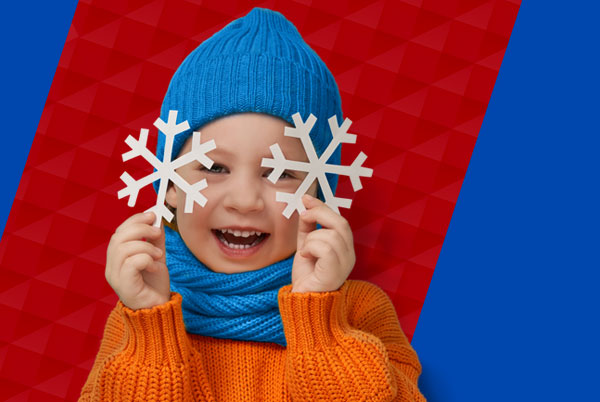 Child holding paper snowflake.